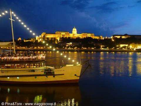 Illuminated boat on the Danube with Buda Castle at night