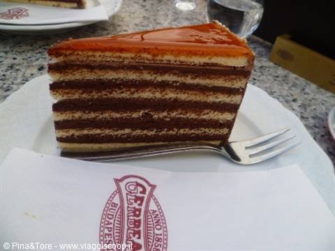 Layered chocolate cake with glaze on a plate at Gerbeaud Café, Budapest