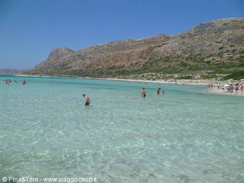 Bathers wading in the shallow turquoise lagoon of Balos, Crete