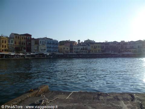 Chania old harbour, colourful facades overlooking the water from the stone pier