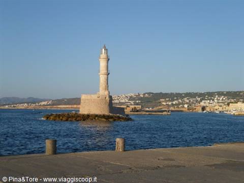 Venetian stone lighthouse at Chania harbor entrance in morning light