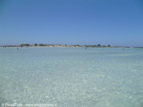 Shallow turquoise lagoon with sandy bottom, bathers at Elafonisi, Crete