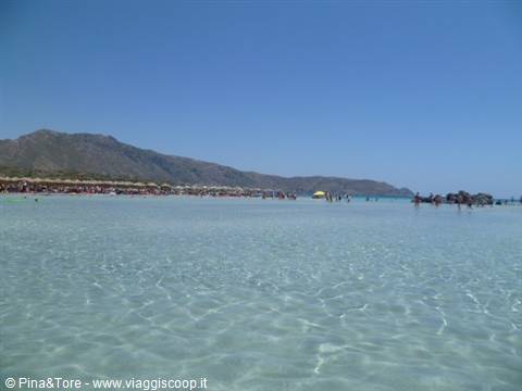 Shallow crystal-clear water and mountains on Elafonisi beach, Crete