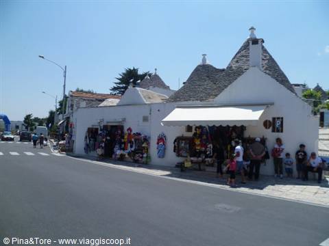 Souvenir shops in trullo houses in Alberobello under midday sun