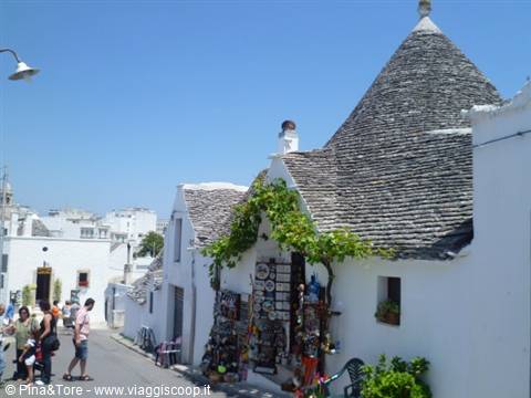 Trulli in Alberobello, conical stone roofs, souvenir shop under the pergola