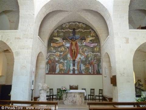 Altar with Christ mosaic surrounded by angels, white stone church with vaults