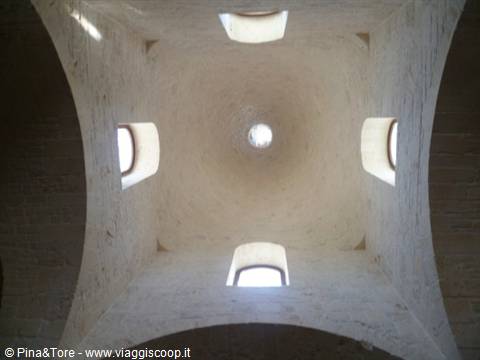 White stone dome with four windows, light through the central oculus