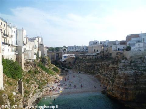 Polignano a Mare, Lama Monachile beach between limestone cliffs and white houses