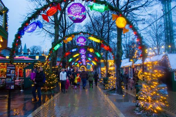 Quality Street candy arches glowing over visitors at Copenhagen's Tivoli Gardens Christmas market