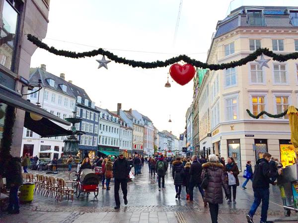 Pedestrians under Christmas garlands with red heart on Strøget, Copenhagen