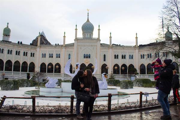 Couple embracing in front of the Moorish pavilion at Tivoli Gardens, Copenhagen