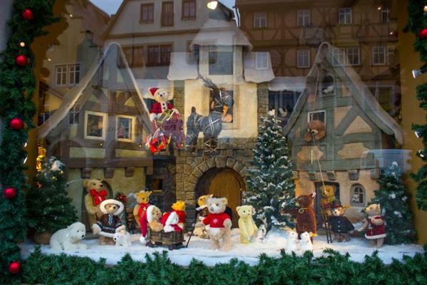 Christmas window display with teddy bears among snowy half-timbered houses