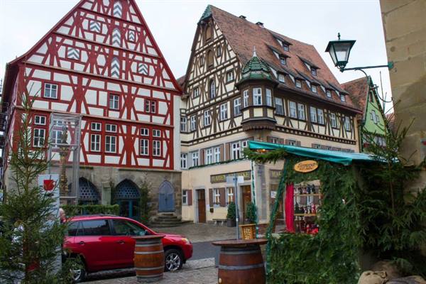 Red and brown half-timbered houses in Rothenburg, Christmas market with wooden barrels