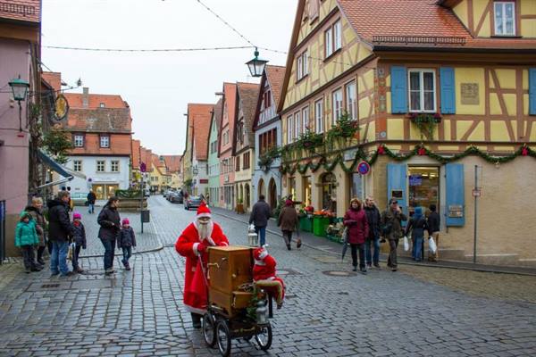 Santa Claus with wooden cart on cobbled street in Rothenburg
