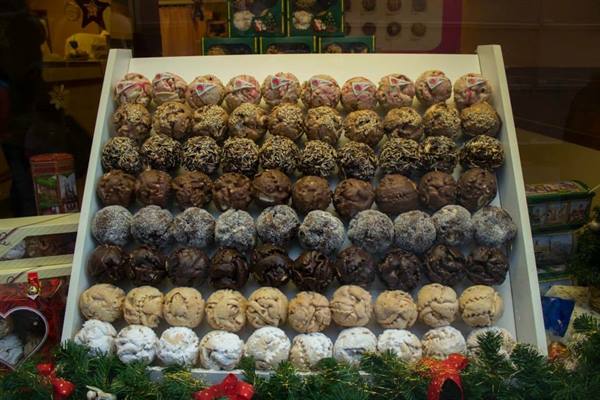 Christmas shop window with rows of decorated chocolate truffles