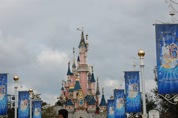 Pink and blue Disneyland Paris castle with 15th anniversary banners