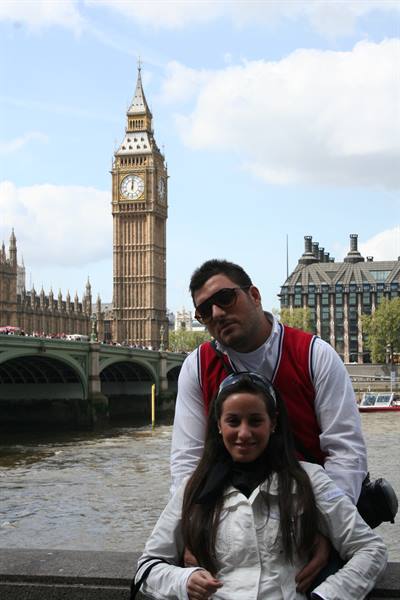 Couple posing by the Thames with Big Ben and Westminster Bridge, London