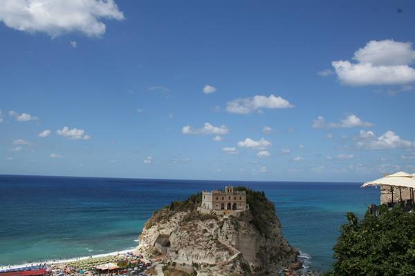 Santa Maria dell'Isola sanctuary on rock at Tropea, crowded beach below