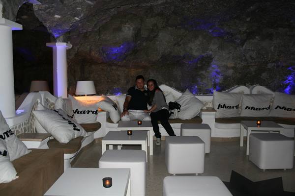 Couple sitting on white sofas in a lounge carved into a cave
