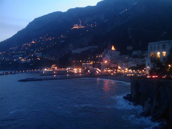 Amalfi at dusk: town lights on the beach, dark mountains and sea
