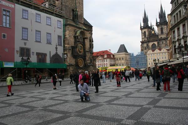 Tourists on Old Town Square with the astronomical clock and Týn Church