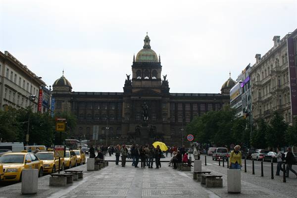 Yellow taxis and tourists on Wenceslas Square facing the National Museum in Prague