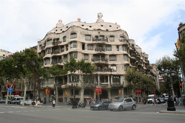 Gaudí's Casa Milà in Barcelona, wavy stone facade, traffic below