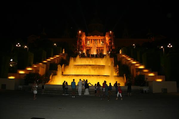 Tourists in front of the illuminated Montjuïc fountain, Barcelona, at night