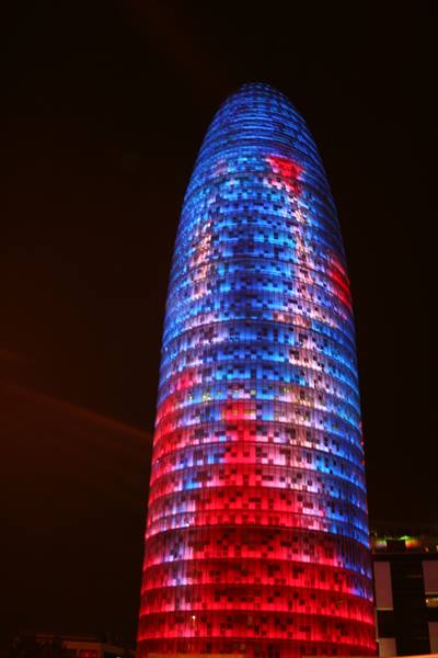Barcelona's Torre Agbar glowing red and blue at night