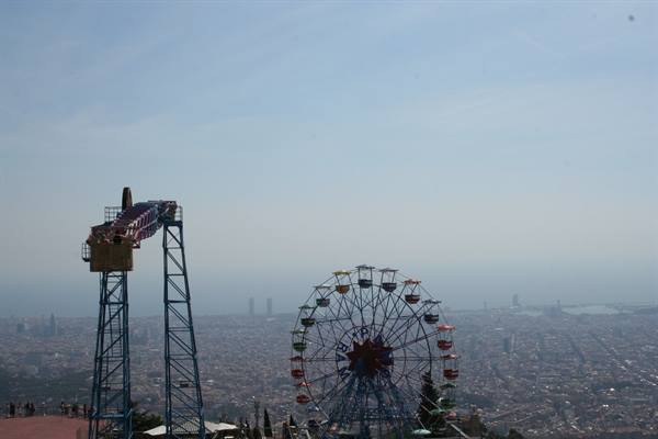 Tibidabo's Ferris wheel and drop tower above Barcelona