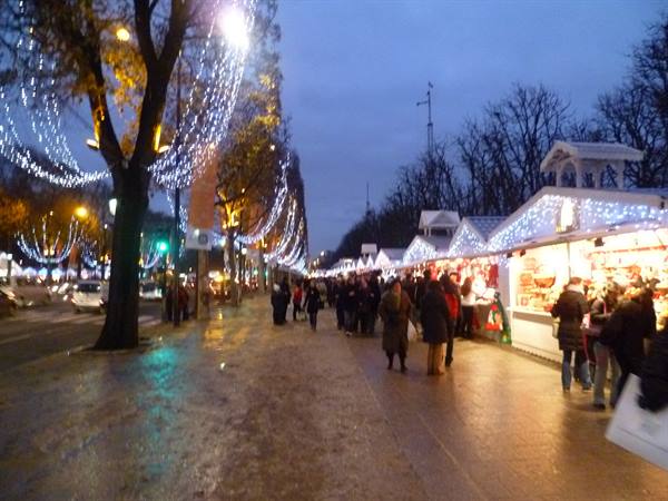 Christmas market on the Champs-Élysées, lit wooden stalls and strolling crowds