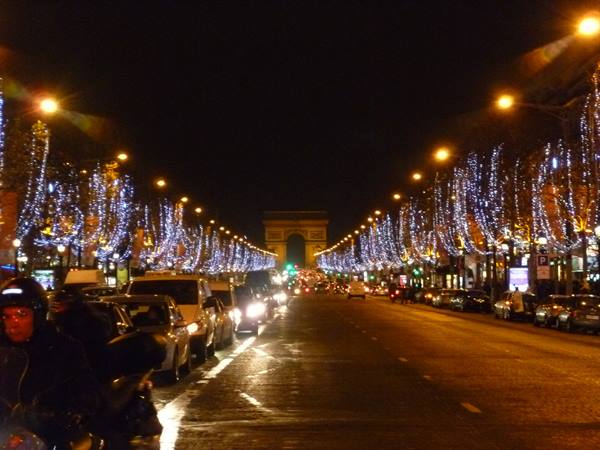 Traffic and Christmas lights on the Champs-Élysées toward the Arc de Triomphe