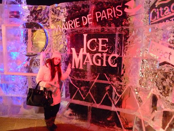 Woman in white coat beside the Ice Magic ice wall, Mairie de Paris