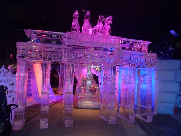 Brandenburg Gate carved in ice, lit in pink and blue