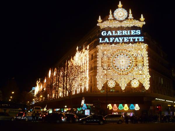 Galeries Lafayette in Paris glowing with golden holiday lights at night