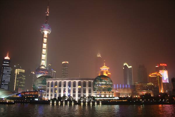 Oriental Pearl Tower and lit Pudong skyscrapers seen from the Bund at night