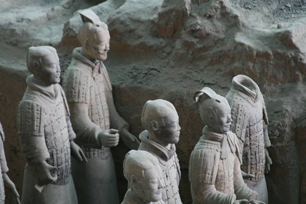 Terracotta warriors in armor standing inside the Xi'an excavation pit