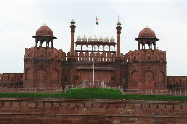 Red Fort in Delhi: red sandstone walls, domed pavilions and Indian flag