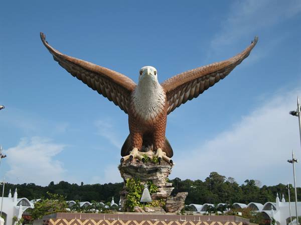 Giant eagle statue with spread wings on rocky square in Langkawi