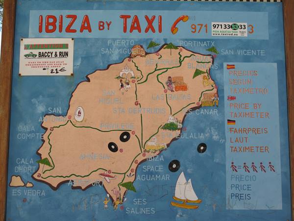 Painted sign with a tourist map of Ibiza island and taxi fares