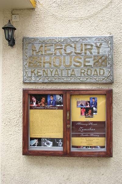 Metal sign Mercurys House on Kenyatta Road with wooden notice panels