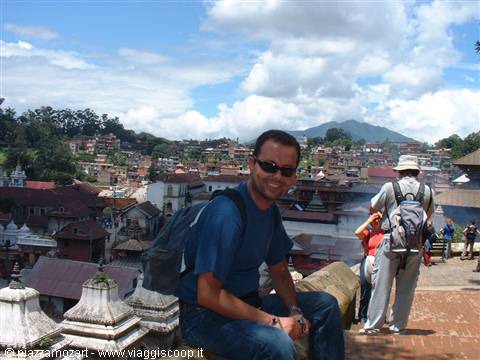 Smiling tourist with backpack on the rooftops of Pashupatinath, Kathmandu