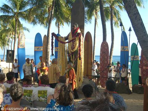 Lei ceremony at Duke Kahanamoku statue in Waikiki, surrounded by surfboards