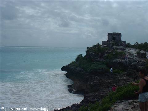 Mayan stone temple on Tulum cliff, waves crashing on rocks below