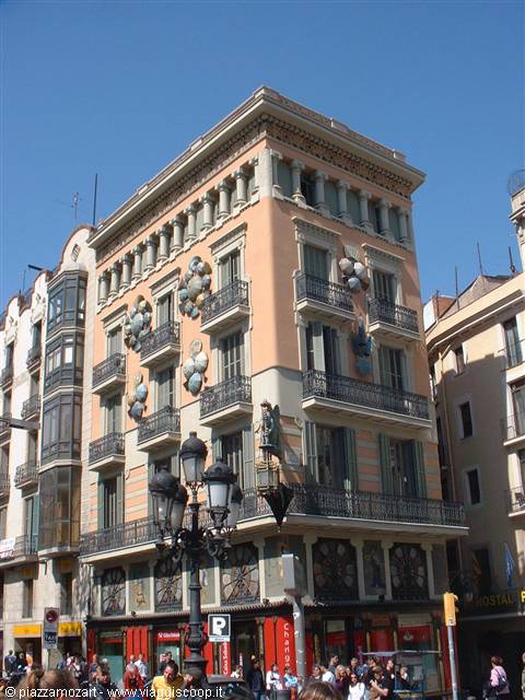 Building with wrought-iron balconies and facade statues, Las Ramblas, Barcelona