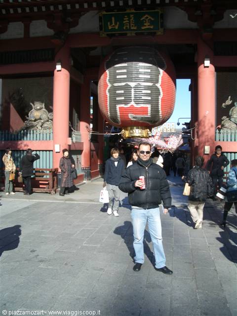 Tourist in front of the giant red lantern of Kaminarimon gate, Tokyo
