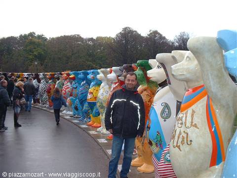 Man among the painted bear sculptures of the United Buddy Bears exhibition