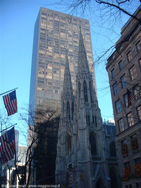 Gothic spires of St. Patrick's Cathedral among skyscrapers and American flags, New York