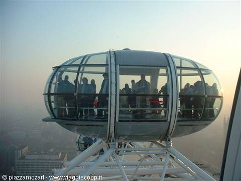 Tourists inside the London Eye glass capsule in morning haze
