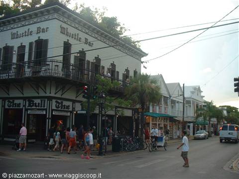 Whistle Bar on Duval Street in Key West, tourists strolling at dusk